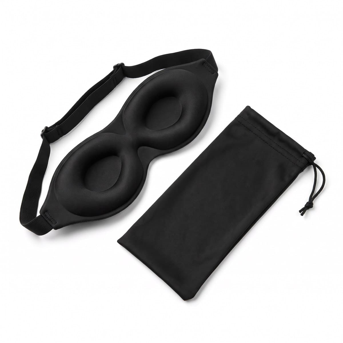 A black contoured sleep mask with moulded eye cups and an adjustable band, its drawstring pouch beside it