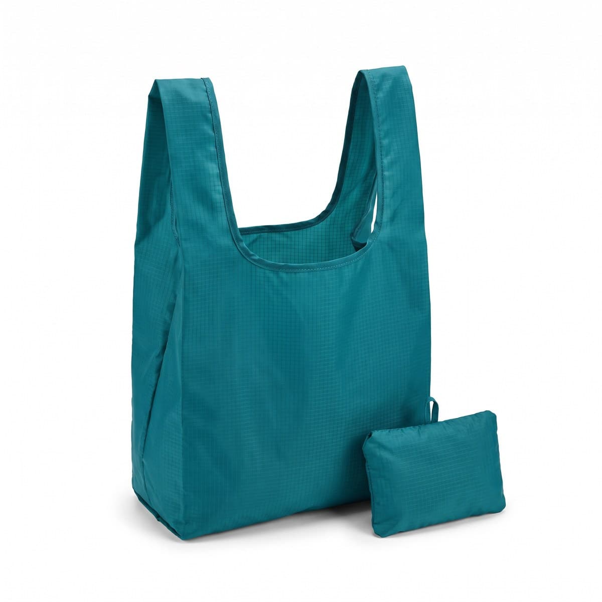 A teal ripstop tote bag standing open beside the small folded pocket it packs into